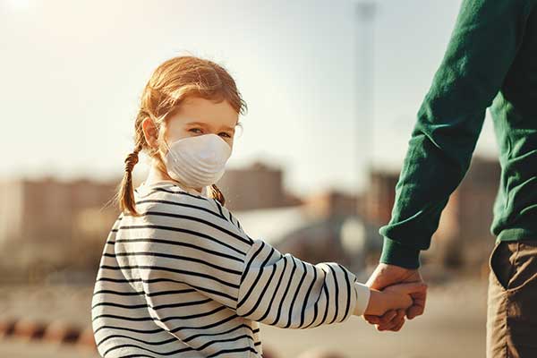girl holding parent's hand