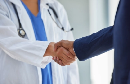 Physician shaking hands with patient.