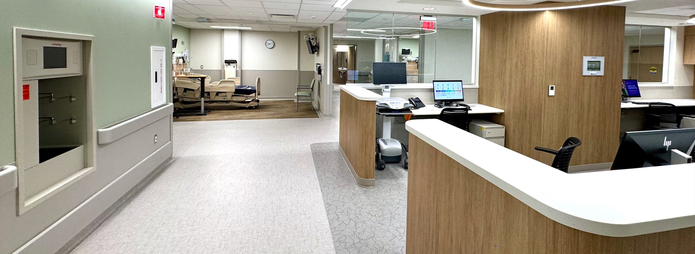 new nurses' station with patient room visible at end of hall