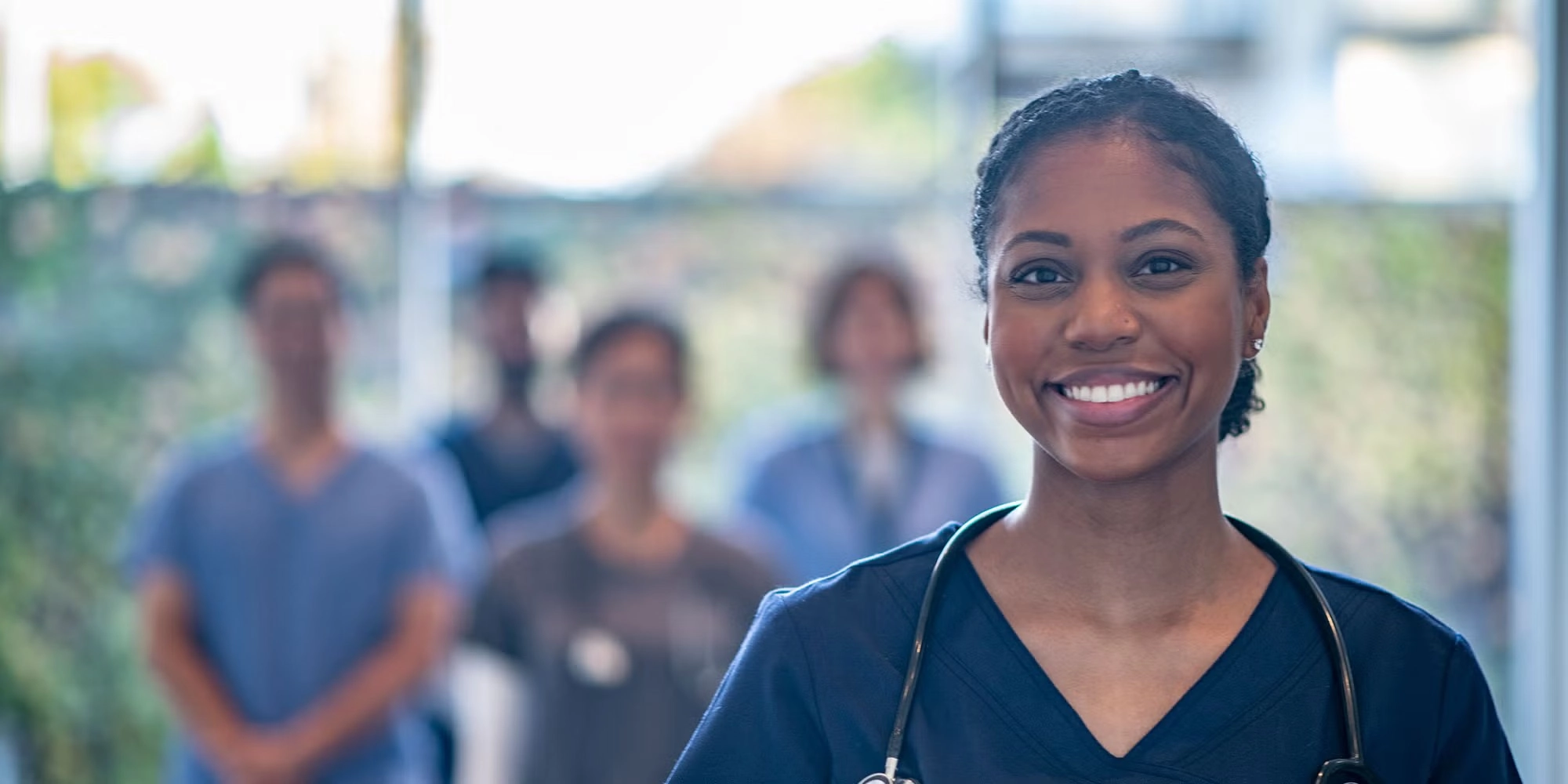 A group of medical residents gather in a hospital hallway