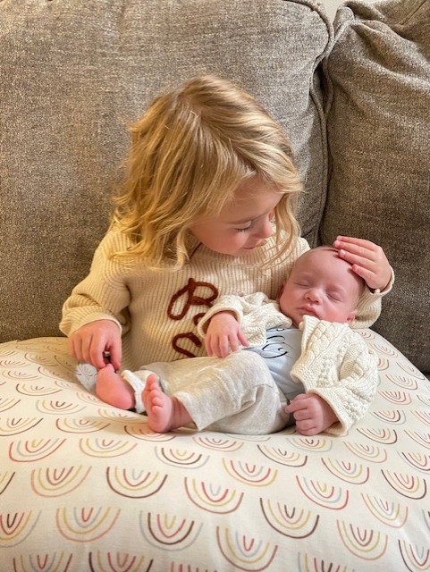 Everly holding Henrik and stroking his head