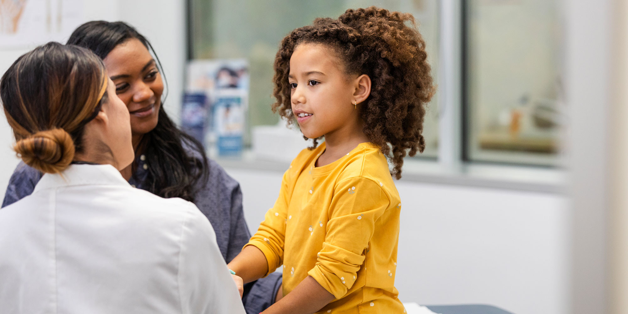 mother and daughter talking with provider