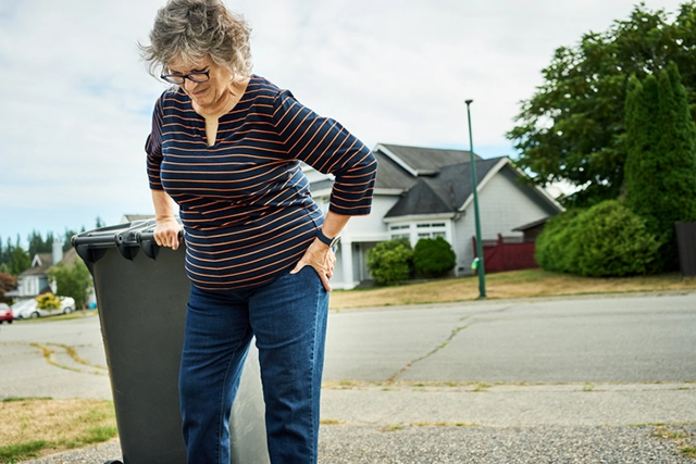 An elderly woman brings in the trash and has sudden pain in her hips.